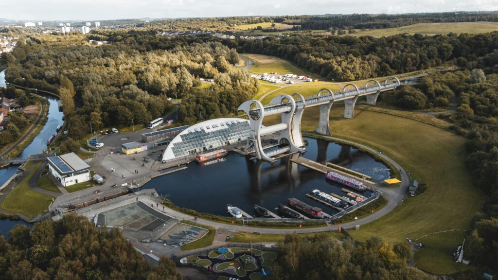 Image shows an aerial view of the Falkirk Wheel with the Falkirk Flight in the distance