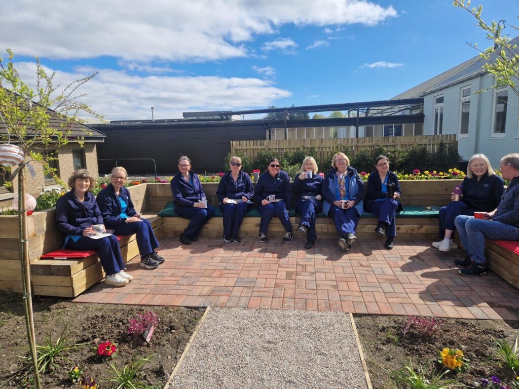A group of medical staff having tea in an outdoor space